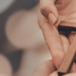 image of hands and cross for Education as Discipleship at Arise Home Education