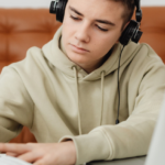 image of teen boy with computer and books, Preparing for GCSE Exams | Academic Readiness part 2 at AriseHomeEducation.com