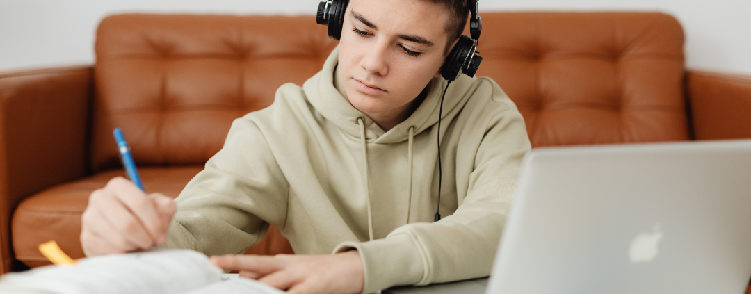image of teen boy with computer and books, Preparing for GCSE Exams | Academic Readiness part 2 at AriseHomeEducation.com